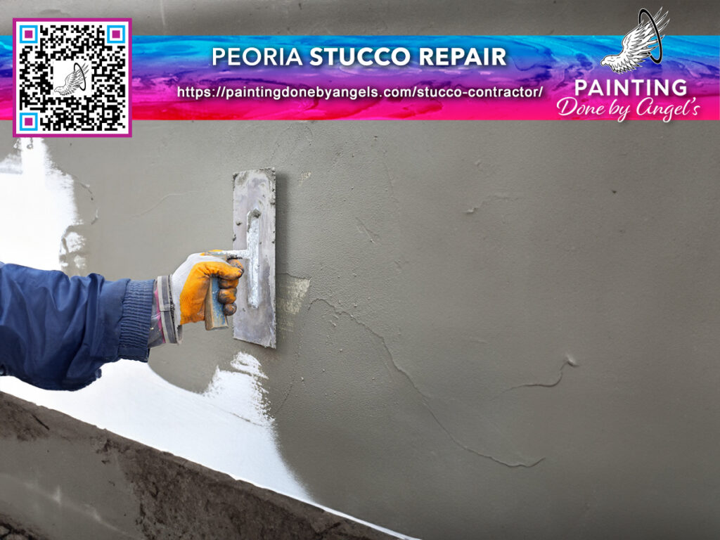 A skilled worker applies stucco to a wall with precision, as part of a professional stucco repair and exterior painting service by a company that also offers interior painting solutions.