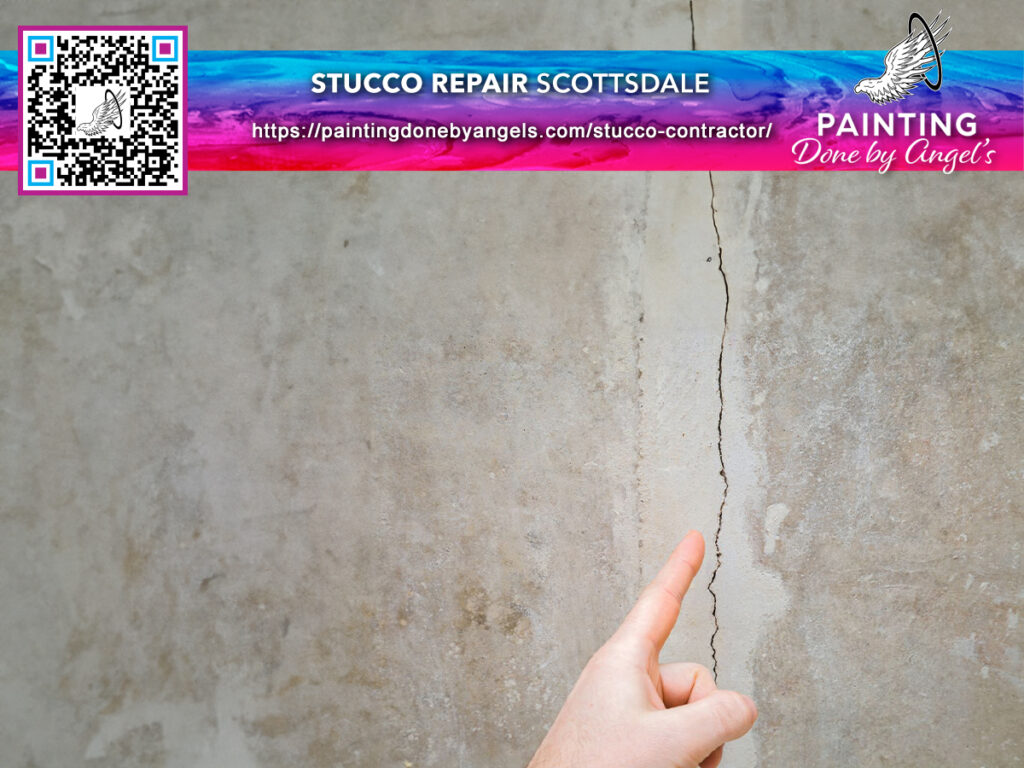 A person is pointing to a vertical crack on a textured wall in need of stucco repair, with an advertisement for Painting Services in Scottsdale and a painting company's branding present.