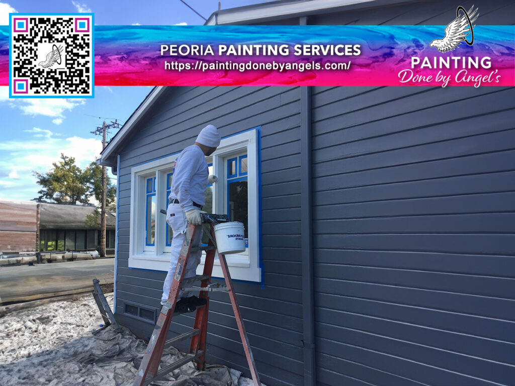 A professional painter from Peoria painting services applying a fresh coat of paint to the exterior of a house, one detail at a time, including stucco repair.