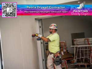 A professional drywall contractor at work, installing or repairing a wall, with a focus on quality and attention to Auto Draft detail.