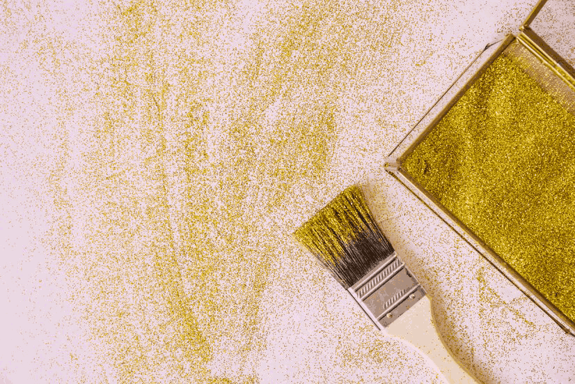 Unleashing creativity with a splash of glitter: a painting company's brush and open glitter container spill vibrant sparkles onto a canvas of possibility.