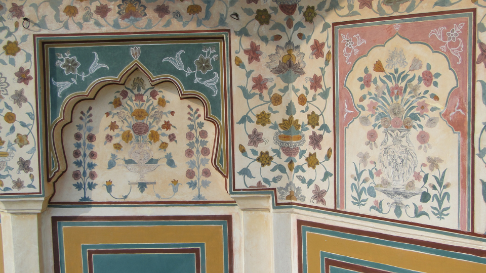 Intricately painted floral motifs adorn an old wall, showcasing a traditional style of interior painting with vibrant colors and detailed designs, capturing the essence of historical craftsmanship.