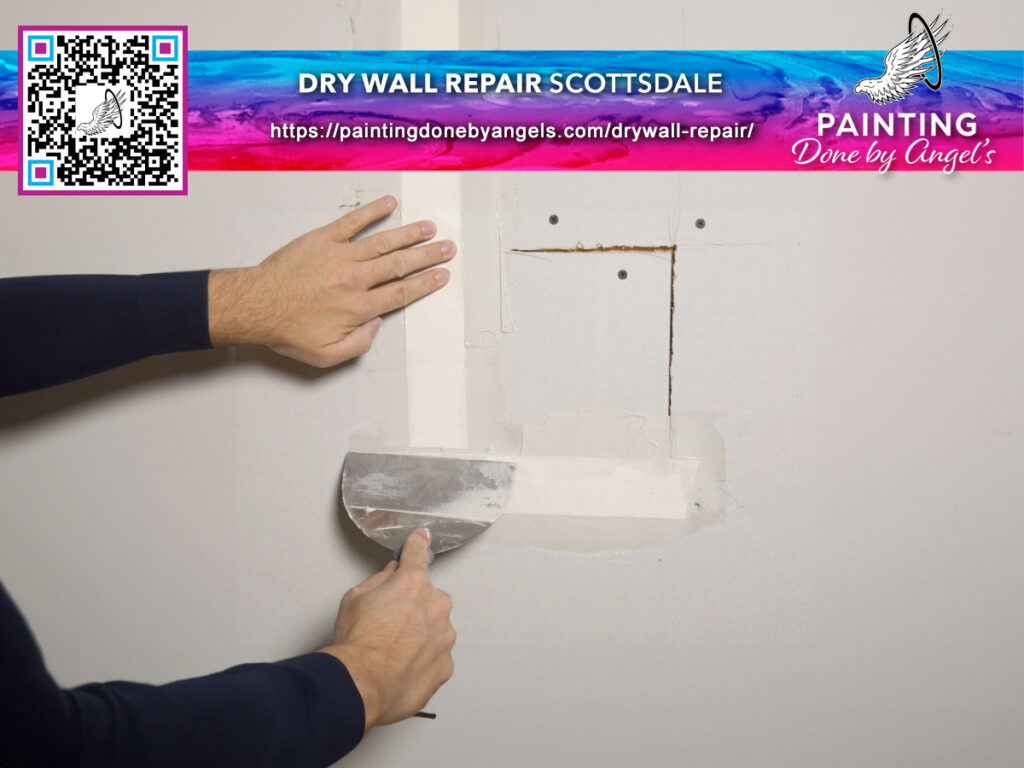 A professional worker skillfully applies joint compound to a wall patch during a drywall repair process, ensuring the surface is perfectly prepped for painting by a reputable Painting Company.