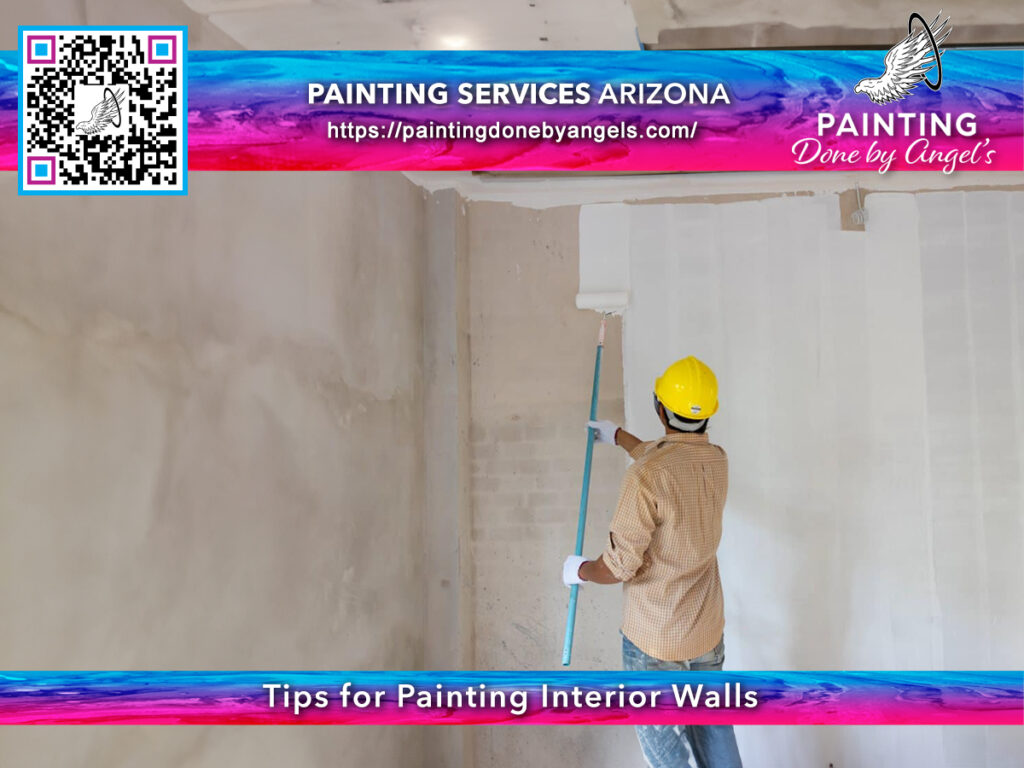 A professional painter diligently working on an interior wall, showcasing the services of interior painting done by a painting company in Arizona. A safety helmet included, ensuring a focus on both craftsmanship and safety.