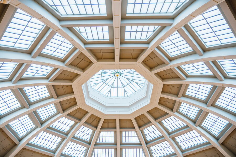 Geometric elegance: a symphony of lines and light in a modern architectural dome, enhanced by the artistry of an exterior painting company.