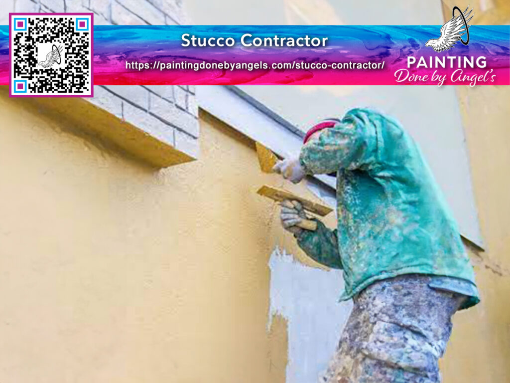 A stucco contractor in a green uniform applies stucco to a yellow wall, with an advertisement including a QR code for "painting done by angels" visible in the corner.